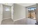 Bright and spacious living room with a small circular window and sliding door leading to the patio at 2966 Juniper Hills Blvd # 204, Las Vegas, NV 89142