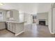 Open-concept living room featuring modern countertops and appliances with a view of the fireplace and entry door at 2966 Juniper Hills Blvd # 204, Las Vegas, NV 89142