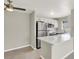 Well-lit living room boasting sleek flooring, a ceiling fan, and easy access to the adjacent modern kitchen at 2966 Juniper Hills Blvd # 204, Las Vegas, NV 89142