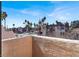 Sunny view from the patio of palm trees, landscaping, and other condos at 2966 Juniper Hills Blvd # 204, Las Vegas, NV 89142