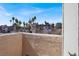 Sunny view from the patio of palm trees, landscaping, and other condos at 2966 Juniper Hills Blvd # 204, Las Vegas, NV 89142