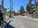 Community entrance showcasing the gate and tree-lined street at 2966 Juniper Hills Blvd # 204, Las Vegas, NV 89142