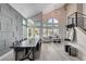 Bright open-plan living room featuring high ceilings, modern chandelier, fireplace, staircase, and dining area at 3012 Waterside Cir, Las Vegas, NV 89117