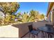 Comfortable balcony set features an iron table with chair, and a view of palm trees at 3098 Quail Crest Ave, Henderson, NV 89052
