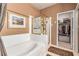 Bright bathroom featuring a soaking tub, glass shower, and a walk-in closet at 3098 Quail Crest Ave, Henderson, NV 89052