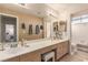 Bathroom featuring double sinks, a large mirror, vanity cabinets, and a separate toilet and shower at 3098 Quail Crest Ave, Henderson, NV 89052