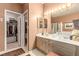 Bathroom featuring double sinks, a large mirror, and a walk-in closet at 3098 Quail Crest Ave, Henderson, NV 89052