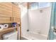 Compact bathroom offers a clean, white tile tub, with modern fixtures and shelving at 3098 Quail Crest Ave, Henderson, NV 89052