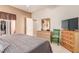 Cozy bedroom featuring a comfortable bed, wooden dresser, and closet at 3098 Quail Crest Ave, Henderson, NV 89052