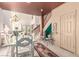 Elegant dining area with a glass-top table, staircase, and stylish decor at 3098 Quail Crest Ave, Henderson, NV 89052