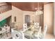 Stylish dining area with a glass-top table, unique decor, and seamless access to other rooms at 3098 Quail Crest Ave, Henderson, NV 89052