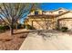 Charming two-story home with a tile roof, a two-car garage, mature trees, and landscaped front yard at 3098 Quail Crest Ave, Henderson, NV 89052