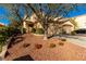 Attractive two-story home with a tile roof, a two-car garage, mature trees, and a rock landscaped front yard at 3098 Quail Crest Ave, Henderson, NV 89052