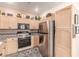 Bright kitchen with stainless steel fridge and decorative upper cabinets at 3098 Quail Crest Ave, Henderson, NV 89052