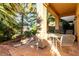 Enclosed patio with pavers features a seating area surrounded by mature trees and greenery at 3098 Quail Crest Ave, Henderson, NV 89052