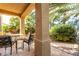Relaxing covered patio with comfortable seating surrounded by lush greenery and shade at 3098 Quail Crest Ave, Henderson, NV 89052