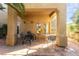 Charming patio area with stucco columns, outdoor seating, and access to the home's interior at 3098 Quail Crest Ave, Henderson, NV 89052