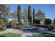 Community water fountain with landscaping, surrounding trees, and benches at 3098 Quail Crest Ave, Henderson, NV 89052