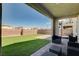 A covered patio extends to a backyard with artificial turf and a brick perimeter at 3524 Crotone Ave, Henderson, NV 89044