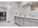 Bathroom featuring dual sinks, gray cabinets, ample counter space, and a walk-in closet at 3524 Crotone Ave, Henderson, NV 89044