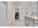 Bathroom featuring dual sinks, gray cabinets, ample counter space, and a walk-in closet at 3524 Crotone Ave, Henderson, NV 89044