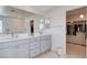 Bright bathroom featuring double sinks, shower, and a walk-in closet at 3524 Crotone Ave, Henderson, NV 89044