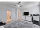 Large primary bedroom with an ensuite bathroom, stairway access, and a workout treadmill at 3524 Crotone Ave, Henderson, NV 89044