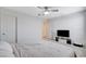 Bright bedroom features a ceiling fan, door to the bathroom, and a TV at 3524 Crotone Ave, Henderson, NV 89044