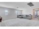Large bonus room with lots of windows, a large gray couch, and neutral carpet at 3524 Crotone Ave, Henderson, NV 89044