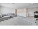 Spacious bonus room features a gray couch and plenty of room for entertainment at 3524 Crotone Ave, Henderson, NV 89044