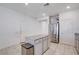 Open-concept kitchen with stainless steel refrigerator and island with granite countertops at 3524 Crotone Ave, Henderson, NV 89044