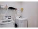 Bright laundry room is equipped with modern appliances and storage shelving at 3524 Crotone Ave, Henderson, NV 89044
