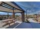 Outdoor park pavilion with picnic table, seating, and beautiful desert mountain views under a bright blue sky at 3524 Crotone Ave, Henderson, NV 89044