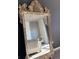Ornate gold-framed mirror reflecting a modern bedroom and natural light at 353 E Bonneville Ave # 447, Las Vegas, NV 89101
