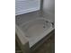 Clean, white bathtub with tile surround and a large window for natural light at 373 Wilford Springs St, Henderson, NV 89014