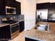 Beautiful kitchen featuring stainless steel appliances, granite countertops, and dark wood cabinets at 373 Wilford Springs St, Henderson, NV 89014