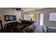 Cozy living room featuring a leather sofa, a ceiling fan, and sliding glass doors at 373 Wilford Springs St, Henderson, NV 89014