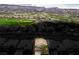 Aerial view showcasing a home and golf course neighborhood with mountains in background at 404 Via Sonador, Henderson, NV 89012