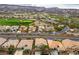 Aerial view of the neighborhood with golf course and mountain views in the background at 404 Via Sonador, Henderson, NV 89012