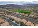 Aerial view of home, golf course community, and desert mountains at 404 Via Sonador, Henderson, NV 89012