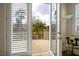 Balcony view through open doors and plantation shutters, inviting outdoor serenity inside at 404 Via Sonador, Henderson, NV 89012