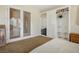 Bedroom features a large closet, neutral carpet, and glass panel french doors at 404 Via Sonador, Henderson, NV 89012