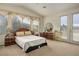 Spacious bedroom with a large window, double doors to balcony, and a vanity area with mirror at 404 Via Sonador, Henderson, NV 89012