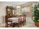 Dining room with China cabinet and large window dressed with elegant curtains at 404 Via Sonador, Henderson, NV 89012