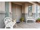 Welcoming front porch featuring a double door, decorative seating, and manicured landscaping at 404 Via Sonador, Henderson, NV 89012