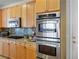 Close up of the kitchen features stainless double oven, microwave and gas range at 404 Via Sonador, Henderson, NV 89012