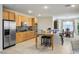 Bright kitchen with stainless refrigerator, island, bar seating and breakfast nook at 404 Via Sonador, Henderson, NV 89012