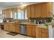 Traditional kitchen with tan cabinets, stainless steel appliances, and tiled backsplash at 404 Via Sonador, Henderson, NV 89012