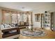 Well lit living room is stylishly decorated with custom window treatments and decor at 404 Via Sonador, Henderson, NV 89012