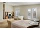 Bright main bedroom featuring plantation shutters and access to a balcony at 404 Via Sonador, Henderson, NV 89012
